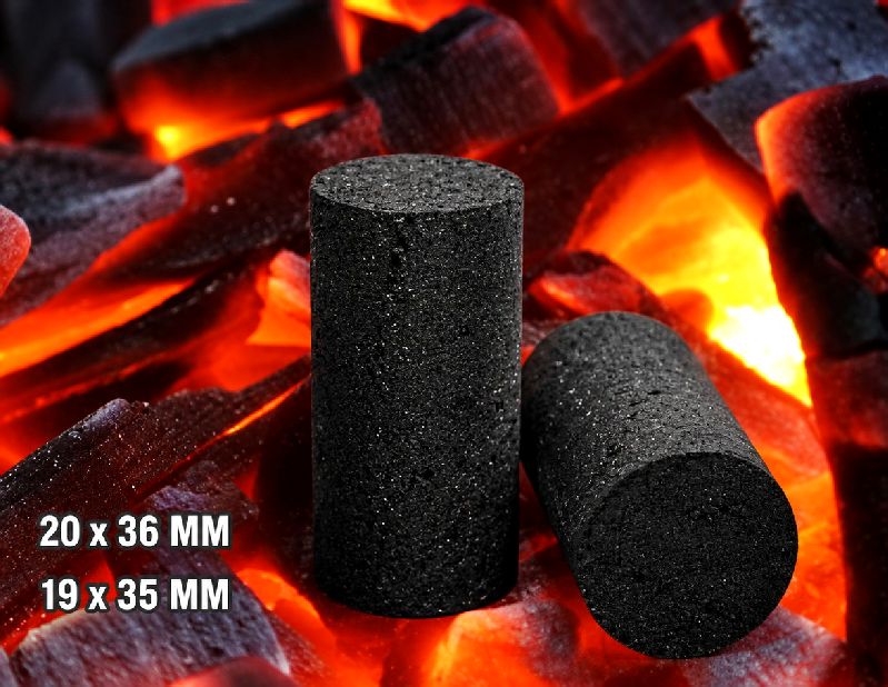 Round cylinder coconut shell charcoal briquettes on glowing embers